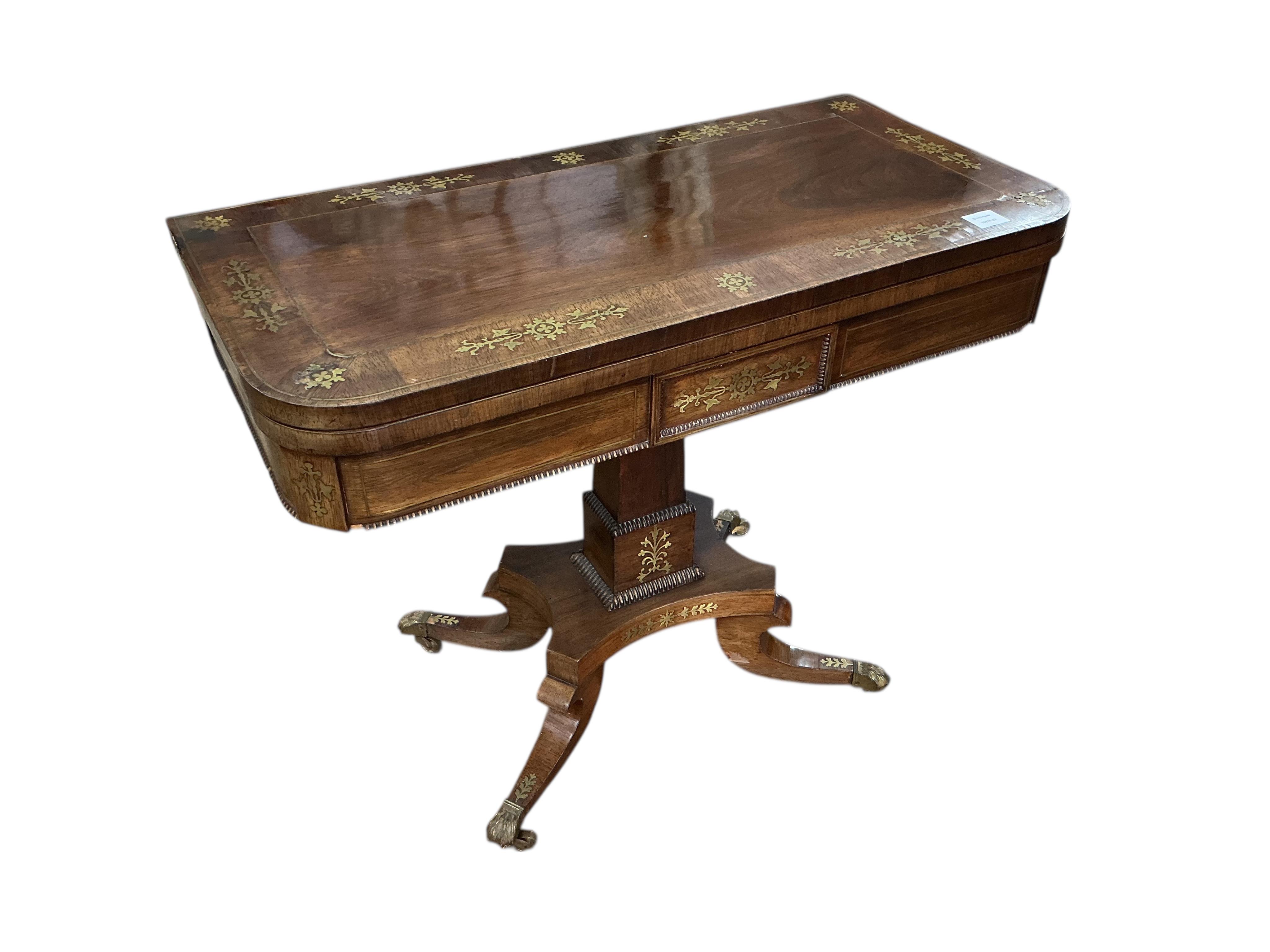 A Regency rosewood and cut brass inlaid pedestal folding card table, width 91cm, depth 45cm, height 73cm